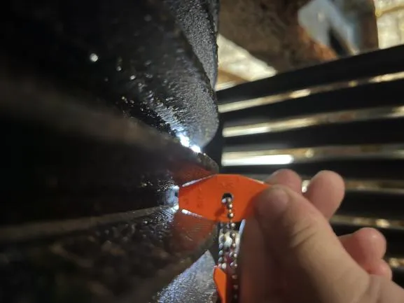 Close inspection of a drive pulley sheave for wear.