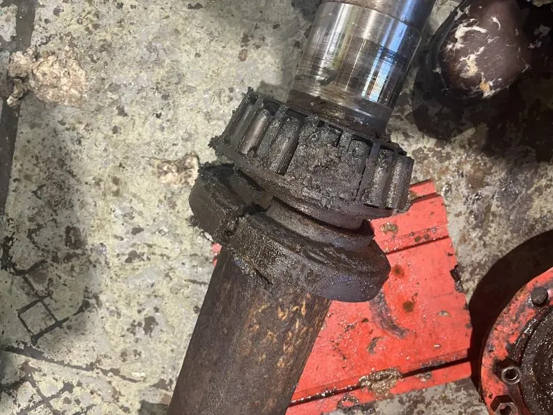 A failed non-drive-end bearing with a damaged grease retaining ring, recorded during strip-down.