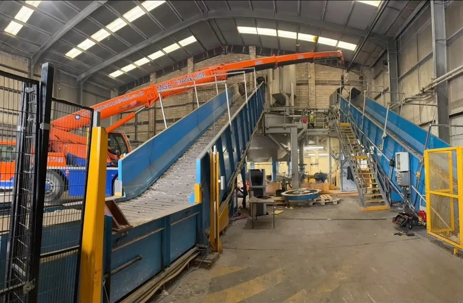 Elevated access platforms with safety railings inside an industrial workshop.